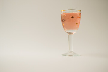 Rose wine in a vintage star glass. Copy space. Shallow depth of field.