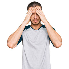 Fototapeta premium Hispanic young man wearing casual clothes suffering from headache desperate and stressed because pain and migraine. hands on head.