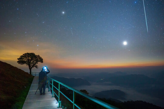 Photographer took the stars on the night of the Geminid constellation there is a meteor shower with a fireball by a Venus over the sea of clouds viewpoint corridor in Mae Hong Son province Thailand.