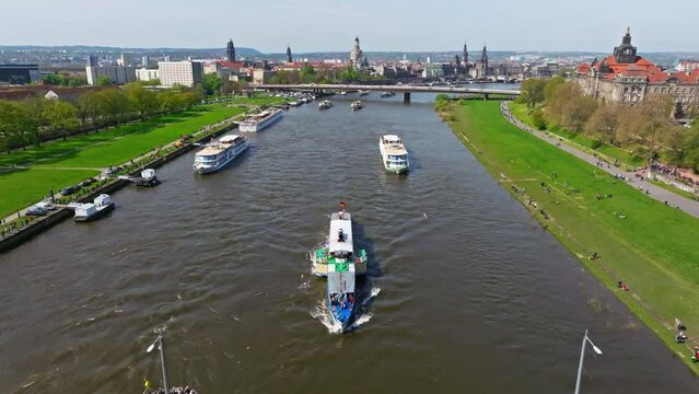Drone video from the steamboat parade in Dresden. Many people are watching enthusiastically on the bank.
