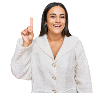 Young brunette woman wearing casual clothes showing and pointing up with finger number one while smiling confident and happy.