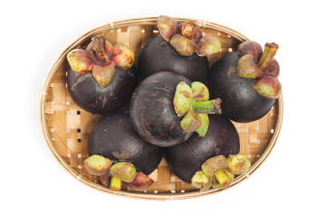 Fresh organic mangosteen delicious fruit in a bamboo basket plate top view isolated on white background clipping path