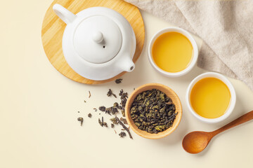 Obraz na płótnie Canvas Tea set with teapot and wood spoon on light beige background