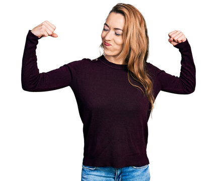 Young caucasian woman wearing casual clothes showing arms muscles smiling proud. fitness concept.