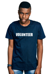 Young african american man wearing volunteer t shirt skeptic and nervous, frowning upset because of problem. negative person.