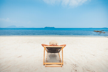 Happy traveler asian woman relax and travel on chair beach in summer Thailand