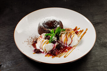 Sweet ice cream dessert with cupcake and syrup