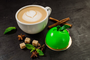 Delicious sweet dessert green apple-shaped cupcake and a cup of coffee on the table