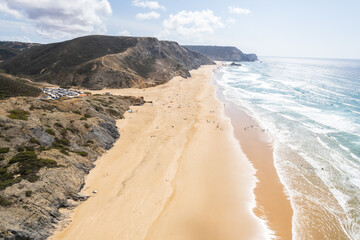 Cordoama beach in Portugal. Aerial drone view of waves, sandy beach and cliffs