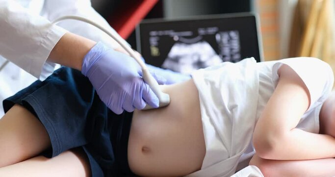 Child undergoing ultrasound to determine position of kidney stones before lithotripsy procedure. Ultrasound of internal organs in children concept