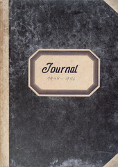 Obraz premium Book cover of a antique ledger accounting book with fabric spine and label with text and year dates 1944-1946