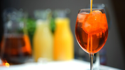 Champagne in an aperol spritz cocktail glass with orange slices. Vacation, summer, vacation, concept of luxury resort and delicious drinks