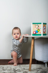 Happy baby making first steps in bedroom