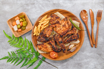 Grilled Charcoal Chicken with Pickles - A Flavorful Culinary Feast. Special Arabic Style Charcoal Chicken with grilled Onion, Tomato and chilli with vegetable pickles 