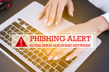 Hand typing on keyboard with text PHISHING ALERT scam, spam, malware, spyware. Information poster.
