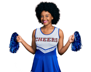 Young african american woman wearing cheerleader uniform using pompom smiling with a happy and cool smile on face. showing teeth.