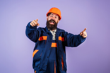Fototapeta premium Excited Worker in hardhat. Construction Worker with helmet. Worker in helmet at building. Portrait of Engineer Builder with Helmet. Worker from building site. Workers helmet and uniform.