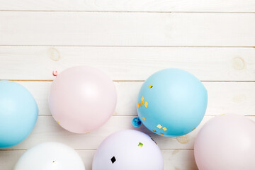 Background with fastive air balloons of round shape and confetti, multicoloured top view. Birthday party background