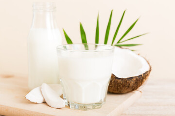 coconut products on white wooden table background. Dairy free milk substitute drink, Flat lay healthy eating