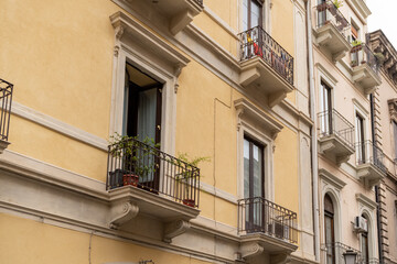 Fototapeta na wymiar Facade of the house with balcony in Catania Sicily Italy.
