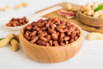 Fresh healthy peanuts in bowl on colored table background. Top view Healthy eating bertholletia concept. Super foods