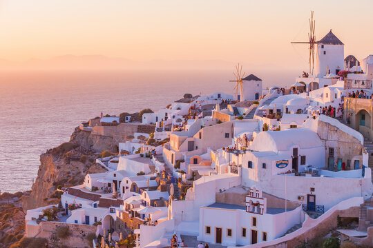 View of Oia at sunset, a small town with whitewashed houses and windmills on Santorini Island, Cyclades islands archipelagos, Aegean Sea, Greece.