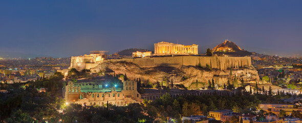 View of the Acropolis of Athens at night, a ruins complex of Greek Temples on hilltop in Athens downtown, Greece.
