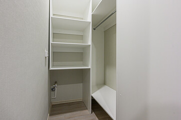 Fototapeta na wymiar interior apartment room dressing room, hangers, storage system