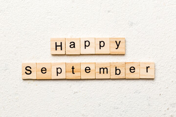 Happy september word written on wood block. Happy september text on table, concept