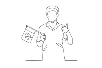 A man holding a Pakistani flag in his right hand while posing