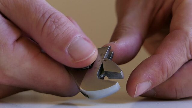Man adjusting adjustable wrench, spanner close up