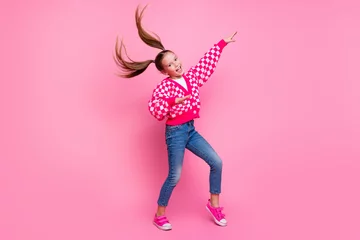 Keuken foto achterwand Dansschool Full size photo of nice lovely schoolgirl with fluttering tails dressed knit cardigan jeans dancing isolated on pink color background