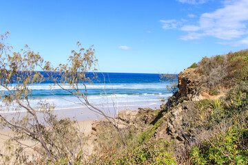 Fototapeta na wymiar A Tranquil Beach Scene with Lush Greenery and Blue Waters
