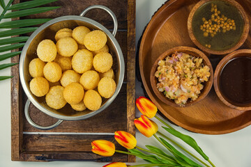 Gourmet Delight: Vibrant Pani Puri, India's Irresistible Street Food Sensation. The golden, crispy puris filled with a delightful spiced potatoes, chickpeas, and tamarind chutney with spiced water