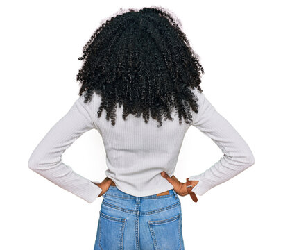 Young african american girl wearing casual clothes standing backwards looking away with arms on body