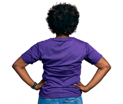 African american woman with afro hair wearing casual purple t shirt standing backwards looking away with arms on body