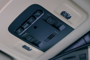 push switches for adjusting the sunroof and interior lights in modern car, shallow depth of field,...