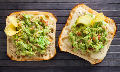 Morning toast with melted cheese and guacamol. top view