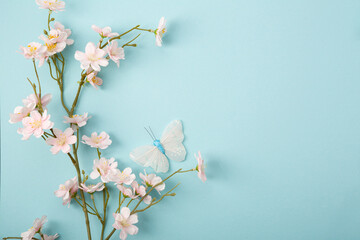 Blue spring paper background and pink flowers