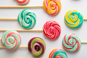 Fototapeta na wymiar Spiral lolly pops candy on sticks on light surface