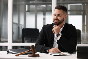 Portrait of smiling lawyer at table in office