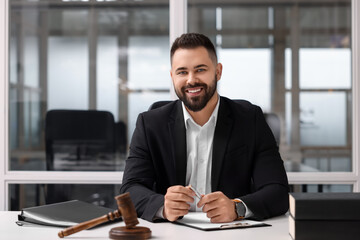 Portrait of smiling lawyer at table in office