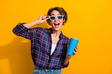 Photo of funky ecstatic woman dressed plaid shirt touch 3d glasses hold popcorn watch comedy at...