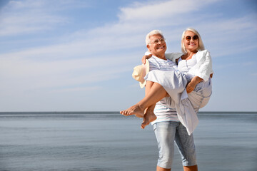 Mature couple spending time together near sea