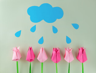 Tulips with cloud and rain made of colored paper on a green background, handmade, craft, applique. Mother's day, women's day concept.
