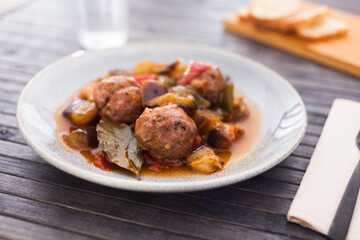 Cooked meatballs with stewed eggplant in bowl