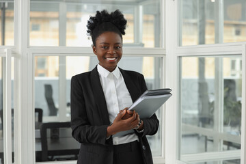 Fototapeta premium Happy woman with folders in office. Lawyer, businesswoman, accountant or manager