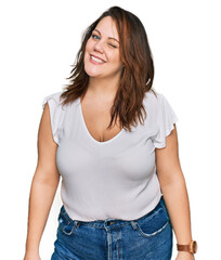 Obraz premium Young plus size woman wearing casual white t shirt winking looking at the camera with sexy expression, cheerful and happy face.