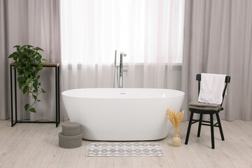 Stylish bathroom interior with soft bath mat and tub - obrazy, fototapety, plakaty