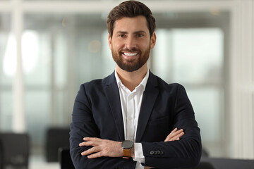Portrait of smiling man with crossed arms in office. Lawyer, businessman, accountant or manager